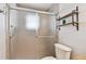Bathroom featuring a walk-in shower and wood shelving at 701 Poinsettia Rd # 322, Belleair, FL 33756
