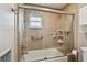 Modern bathroom with glass-enclosed shower, tiled walls, and convenient grab bars at 701 Poinsettia Rd # 322, Belleair, FL 33756