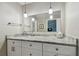 Bathroom vanity with modern fixtures, granite countertops, pendant lighting, and large mirrors at 701 Poinsettia Rd # 322, Belleair, FL 33756