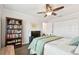 Bright bedroom features a ceiling fan, a bookshelf, and an ample amount of closet space at 701 Poinsettia Rd # 322, Belleair, FL 33756