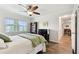 Bright bedroom features a window view, hard floors and a ceiling fan at 701 Poinsettia Rd # 322, Belleair, FL 33756