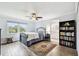 The bedroom features hardwood floors, ceiling fan, and a doorway to the bathroom at 701 Poinsettia Rd # 322, Belleair, FL 33756