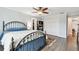 Bedroom featuring hardwood floors, ceiling fan, closet, and access to hallway at 701 Poinsettia Rd # 322, Belleair, FL 33756