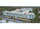 Beautiful exterior view of the condo with palm trees, well maintained landscaping and parking at 701 Poinsettia Rd # 322, Belleair, FL 33756