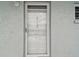 Front door with glass panes and silver hardware with address number 322 at 701 Poinsettia Rd # 322, Belleair, FL 33756