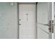 Open front door with glass panes and silver hardware with address number 322 at 701 Poinsettia Rd # 322, Belleair, FL 33756