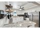 Bright, updated kitchen featuring stainless appliances and stone countertops with stylish backsplash at 701 Poinsettia Rd # 322, Belleair, FL 33756