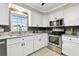 Bright kitchen with white cabinets, stainless steel appliances, and tile backsplash at 701 Poinsettia Rd # 322, Belleair, FL 33756