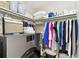 Spacious laundry room with modern washer and dryer, storage shelves, and hanging racks at 701 Poinsettia Rd # 322, Belleair, FL 33756