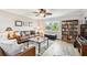 Welcoming living room with ceiling fan, hardwood floors, and natural light from the large window at 701 Poinsettia Rd # 322, Belleair, FL 33756