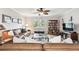 Bright living room boasts a large window, ceiling fan and hardwood floors at 701 Poinsettia Rd # 322, Belleair, FL 33756