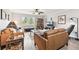 Bright living room features hardwood floors, a ceiling fan, and a large window at 701 Poinsettia Rd # 322, Belleair, FL 33756