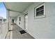 Outdoor walkway with light blue walls, white railing and a fire extinguisher at 701 Poinsettia Rd # 322, Belleair, FL 33756