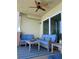 Cozy balcony offering stylish furniture, a striped rug, a ceiling fan, and scenic views through sliding glass doors at 706 Bayway Blvd # 502, Clearwater Beach, FL 33767