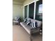 Inviting outdoor balcony with stylish seating, cushions, and views at 706 Bayway Blvd # 502, Clearwater Beach, FL 33767