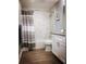 This bathroom features white cabinets, a shower with white tile, and an updated vanity at 706 Bayway Blvd # 502, Clearwater Beach, FL 33767