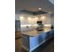 Modern kitchen with stainless steel appliances, sleek countertops, and ample cabinet space at 706 Bayway Blvd # 502, Clearwater Beach, FL 33767