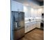 Bright kitchen with stainless steel fridge, light countertops, and wooden flooring at 706 Bayway Blvd # 502, Clearwater Beach, FL 33767