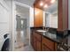 Bathroom features a granite countertop, wood cabinets, and convenient in-unit washer and dryer at 720 Lyndhurst St # 1101, Dunedin, FL 34698