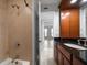Bathroom with a shower, tub, granite countertop sink, and wood cabinet at 720 Lyndhurst St # 1101, Dunedin, FL 34698