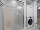Bathroom features a stand up shower and a stackable washer and dryer at 720 Lyndhurst St # 1101, Dunedin, FL 34698
