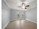 Spacious bedroom with tile flooring, a ceiling fan, and natural light at 720 Lyndhurst St # 1101, Dunedin, FL 34698