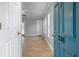 Inviting entryway with neutral tile flooring, blue door, and bright natural light at 720 Lyndhurst St # 1101, Dunedin, FL 34698