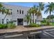 Charming condo building featuring lush landscaping and covered entryway to units on the second floor at 720 Lyndhurst St # 1101, Dunedin, FL 34698