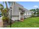 Aerial view of the building featuring balconies, well-kept landscaping, and ample parking at 720 Lyndhurst St # 1101, Dunedin, FL 34698
