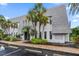 Building exterior with lush landscaping, clearly marked address, and ample parking at 720 Lyndhurst St # 1101, Dunedin, FL 34698