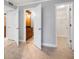 Hallway featuring multiple access points, including a bathroom and walk in closet at 720 Lyndhurst St # 1101, Dunedin, FL 34698