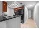 Kitchen featuring black appliances, granite countertops, and track lighting at 720 Lyndhurst St # 1101, Dunedin, FL 34698