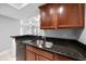 This kitchen features granite countertops, stainless steel sink and a breakfast bar at 720 Lyndhurst St # 1101, Dunedin, FL 34698