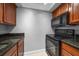 This kitchen features stainless steel appliances, granite countertops and wood cabinets at 720 Lyndhurst St # 1101, Dunedin, FL 34698