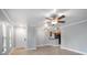 Bright living room with tile flooring, ceiling fan, and an open view into the kitchen at 720 Lyndhurst St # 1101, Dunedin, FL 34698