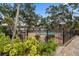 Community pool area with comfortable seating, lush plants, and a secure black metal fence at 720 Lyndhurst St # 1101, Dunedin, FL 34698