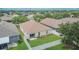 Aerial view of a well-maintained backyard with a white picket fence and a sliding glass door leading inside at 7603 Wood Violet Dr, Gibsonton, FL 33534