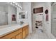 Bright bathroom features a large vanity, cabinet, and a TV for a relaxing and modern experience at 7603 Wood Violet Dr, Gibsonton, FL 33534