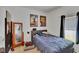 Bedroom boasts carpet, a window with natural light, decor, and a floor mirror at 7603 Wood Violet Dr, Gibsonton, FL 33534