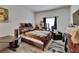 Comfortable bedroom with neutral decor, featuring a large window and cozy seating area at 7603 Wood Violet Dr, Gibsonton, FL 33534