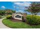 SouthBay Lakes community sign with stone accents, lush landscaping, and flowering trees against a blue sky at 7603 Wood Violet Dr, Gibsonton, FL 33534