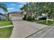 Charming single-story home with a long driveway and mature trees in a quiet neighborhood at 7603 Wood Violet Dr, Gibsonton, FL 33534