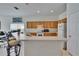 Bright eat-in kitchen with countertop seating and wooden cabinets at 7603 Wood Violet Dr, Gibsonton, FL 33534