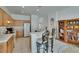 Kitchen with countertop seating, wooden cabinets, and tiled flooring near a glass dining table at 7603 Wood Violet Dr, Gibsonton, FL 33534
