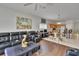 Spacious living room featuring wood flooring and open floorplan with sightlines into the kitchen and dining area at 7603 Wood Violet Dr, Gibsonton, FL 33534