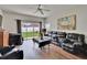 Living room features sliding glass doors to the backyard and contemporary furnishings at 7603 Wood Violet Dr, Gibsonton, FL 33534