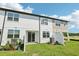 Backyard with sliding glass door and a white fence with grass at 7678 Deer Valley Circle, Tampa, FL 33635