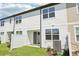 Backyard with sliding glass door and a white fence with grass at 7678 Deer Valley Circle, Tampa, FL 33635