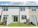 Backyard with sliding glass door and a white fence with grass at 7678 Deer Valley Circle, Tampa, FL 33635