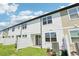 Backyard with sliding glass door and a white fence with grass at 7678 Deer Valley Circle, Tampa, FL 33635